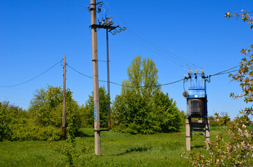 electric transformer and electric pole with wires.