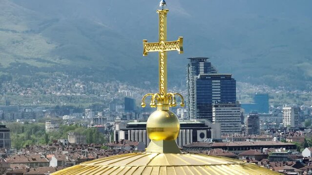 The dome of the cathedral with cross.  sunny day. d-log  10-bit. Golden dome and cross. circle - slide