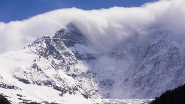 Timelapse of dissolving foehn clouds at Fiescherwand in Switzerland
