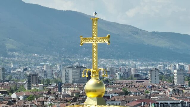 The dome of the cathedral with cross.  sunny day. d-log  10-bit. Golden dome and cross. circle - slide