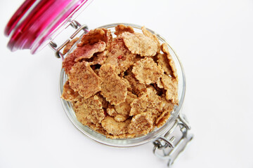oatmeal diet muesli in a glass jar on a white background
