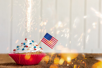 a cupcake with a flag and sparkler