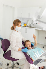 Dentist and kid patient in dentist office
