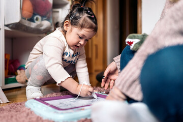 Fototapeta premium Little Girl Drawing at Home