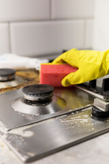 dirty kitchen stove, empty and full bottles of detergents around.
