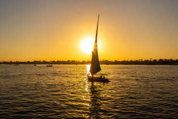 Obraz na płótnie Canvas Sailboat on Nile at sunset