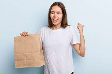 young adult woman shouting aggressively with an angry expression. delivery and take away concept