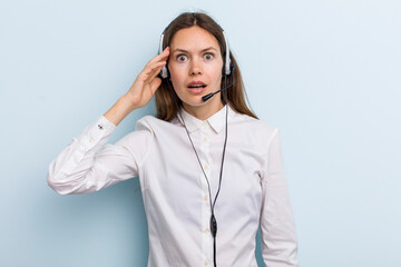 young adult woman looking happy, astonished and surprised. telemarketer concept