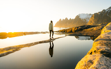 Woman tourist enjoying landscape in Norway adventure travel active healthy lifestyle. Sunset at...