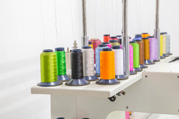 Embroidery threads. The embroidery machine is engaged in embroidery with threads