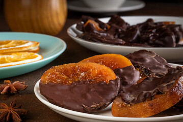 Candied oranges with chocolate. Dryed oranges and cinnamon.