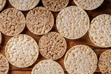 Round crisp breads on wooden background. Wheat crispbreads. Top view.