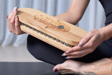 Image of a Sadhu board in female hands. Yoga concept. Spiritual practices.