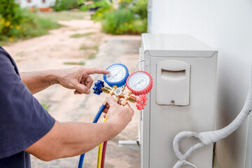Air conditioner technician checking air conditioner operation