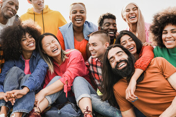 Fototapeta premium Happy young people having fun together at city park - Multiracial friends enjoy day outdoor