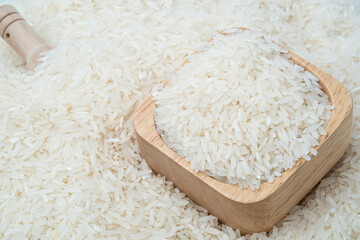 Raw white rice (Uncooked) in wooden bowl on rice grain