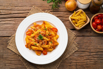 Penne macaroni with Meat Sauce,Easy Penne pasta tossed with a simple tomato sauce with ground pork in white plate.Top view