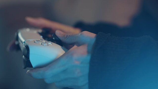 Using controller playing video games - close up of hands and joypad