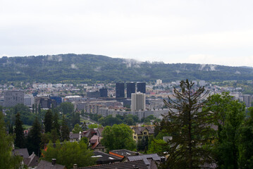 Aerial view over city of Zürich with mountains in the background seen from district Höngg on a cloudy summer day. Photo taken June 5th, 2022, Zurich, Switzerland.