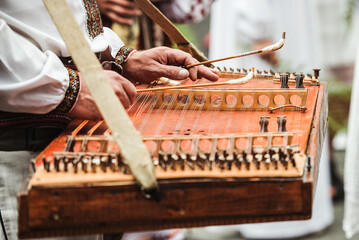 Gusli is an ancient traditional russian musical instrument. Gusli folk musical instrument in men's hands close-up.