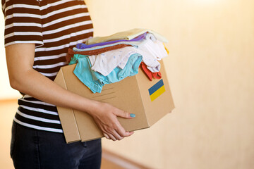 Volunteer cyrrying box with Humanitarian aid for Ukrainian refugees.