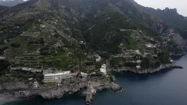 Drone video of empty descriptive plane approaching the city of Maiori, from the distance of the waters to the Normanna tower.