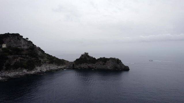 Drone video of a descriptive empty plane in the direction of the Capo de Conca tower, on the Amalfi coast, Italy. Two navengango boats appear in the scene.