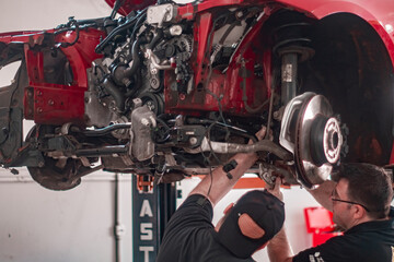 mechanics fixing car motor