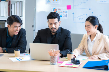A group of young Asian businessmen Talking and planning work happily and have fun. at the company's office