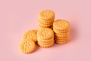 stacks of round cookies on a pink background, copy space