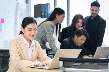 Asian businessman Working and meeting at the office at the company with colleagues at the back