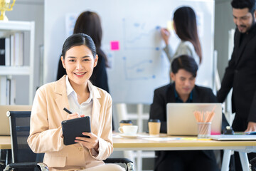 Asian businessman looking at the camera Working and meeting at the office at the company with colleagues at the back