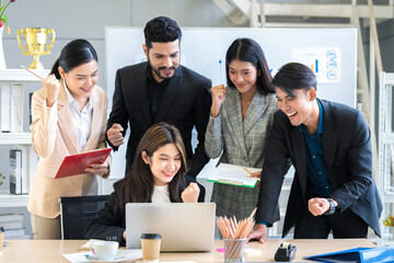 A group of young businessmen in Asian suits are passionate and excited about their work. And to encourage team members and have a commitment to accomplish the assigned tasks professionally.