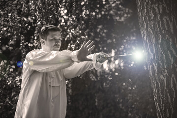 Man wizard with magic wand. Halloween concept, masquerade or cosplay Medieval look