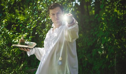 Man wizard with magic wand. Halloween concept, masquerade or cosplay Medieval look