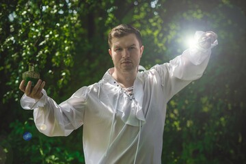 Man wizard with magic wand. Halloween concept, masquerade or cosplay Medieval look