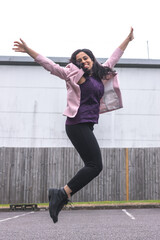 woman in suit jumping with joy