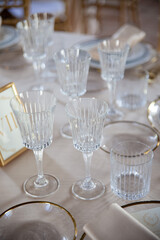 Hall of an ancient castle with catering for wedding events. The tables are set up with fine plates, glasses and cutlery