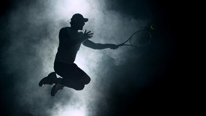 Dramatic tennis player silhouette jumping up in the air