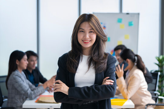 Asian businessman looking at the camera Working and meeting at the office at the company with colleagues at the back