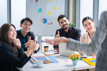 A group of young businessmen in Asian suits are passionate and excited about their work. And to encourage team members and have a commitment to accomplish the assigned tasks professionally.
