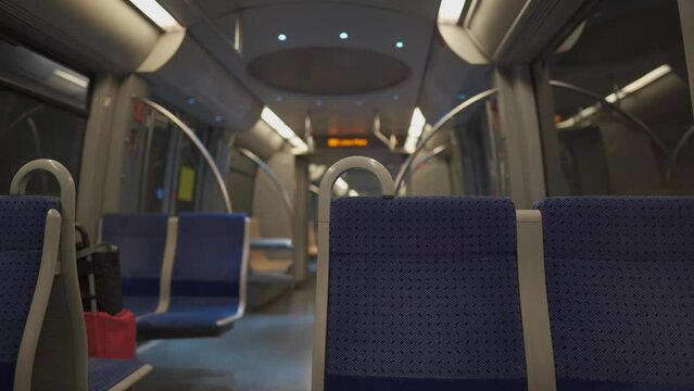Subway in Munich, Germany. The interior of an empty new model metro car with blue seats rides the line. Subway in Bavaria, new empty wagon on the route. U-Bahn Munchen