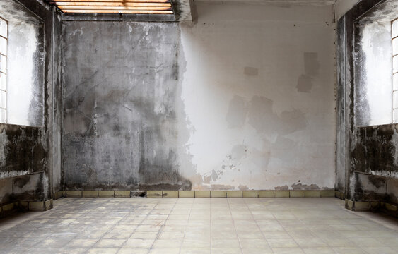 Interior of abandoned and ruined house with broken wall. old interior with broken concrete wall. old brick wall