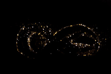 Golden and silver blurred bokeh lights on black background. Glitter sparkle stars for celebrate. Overlay for your design