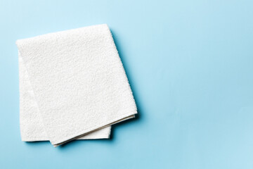 Top view of white towels with copy space on colored background