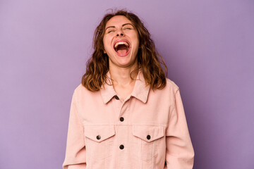 Young caucasian woman isolated on purple background relaxed and happy laughing, neck stretched showing teeth.