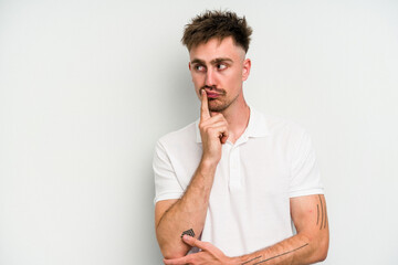 Young caucasian man isolated on white background looking sideways with doubtful and skeptical expression.