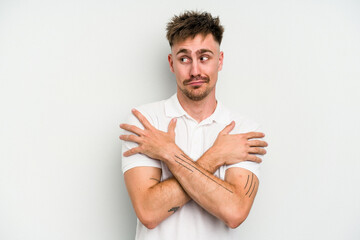 Young caucasian man isolated on white background hugs, smiling carefree and happy.