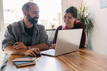 young couple working at home, holding a videoconference