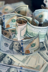 Dollar bills spread out on the table.
